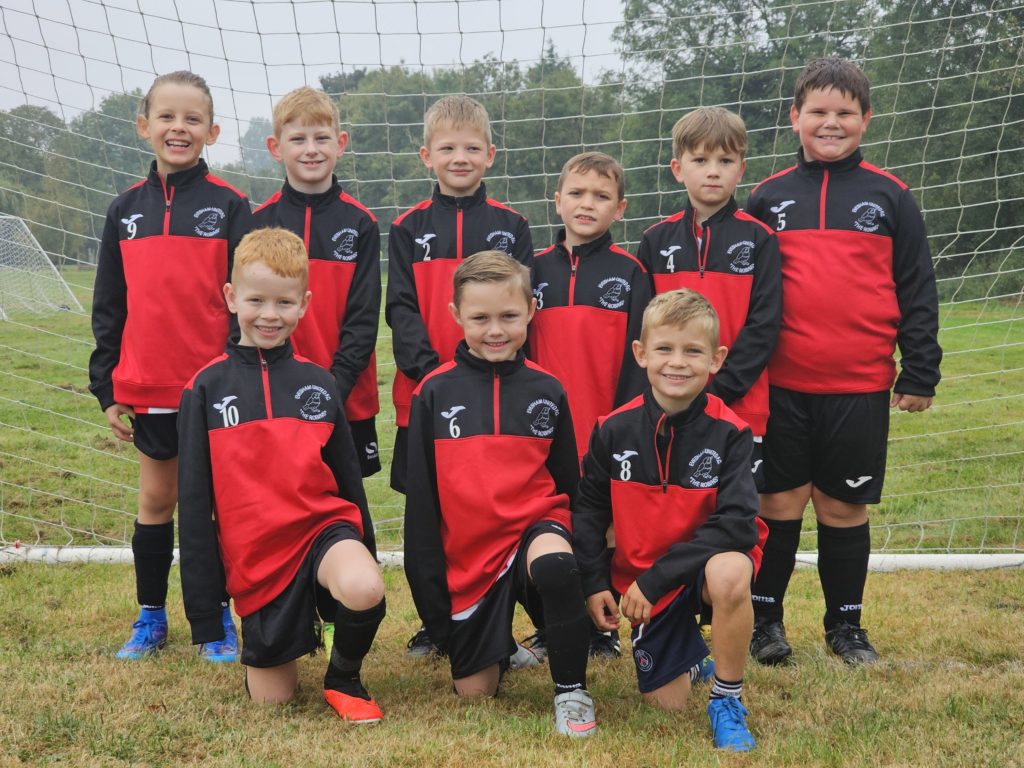 Evesham-Colts U8s football team wearing new jackets